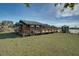 Charming wooden home featuring a spacious deck and gazebo near a lake, perfect for enjoying outdoor living and nature at 15040 Ne 248Th Avenue Rd, Fort Mc Coy, FL 32134