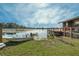 Waterfront property featuring a boat dock, wooden deck, and a serene lake view, perfect for relaxing outdoor enjoyment at 15040 Ne 248Th Avenue Rd, Fort Mc Coy, FL 32134