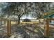 Lovely view of the front yard featuring an open gate to the river, gorgeous trees and a peek at the home's welcoming facade at 15040 Ne 248Th Avenue Rd, Fort Mc Coy, FL 32134