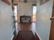 Hallway leading to a dining area with wood floors and an open view to a deck and a beautiful lake view at 15040 Ne 248Th Avenue Rd, Fort Mc Coy, FL 32134