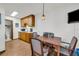 Functional kitchen area with wooden cabinets, a dining table, and adjacent bathroom at 15040 Ne 248Th Avenue Rd, Fort Mc Coy, FL 32134