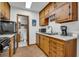 Kitchen boasts wood cabinets, built-in microwave, and access to bathroom at 15040 Ne 248Th Avenue Rd, Fort Mc Coy, FL 32134