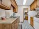 Efficient kitchen with wood cabinets, appliances, and access to bathroom at 15040 Ne 248Th Avenue Rd, Fort Mc Coy, FL 32134