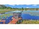 Charming lakeside gazebo with seating, surrounded by peaceful waters and lush vegetation at 15040 Ne 248Th Avenue Rd, Fort Mc Coy, FL 32134