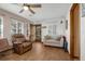 Comfortable living room with a ceiling fan, two sofas, and wood-look tile flooring at 15040 Ne 248Th Avenue Rd, Fort Mc Coy, FL 32134