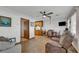 Cozy living area with wood-look floors, ceiling fan, dining area and a comfortable seating arrangement at 15040 Ne 248Th Avenue Rd, Fort Mc Coy, FL 32134