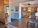 An open-concept living space with wood floors, seamlessly connecting the kitchen, dining area, and outdoor deck access at 15040 Ne 248Th Avenue Rd, Fort Mc Coy, FL 32134