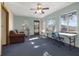 Well-lit living room featuring neutral walls, plush carpeting and multiple windows at 15040 Ne 248Th Avenue Rd, Fort Mc Coy, FL 32134