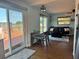 Inviting living room featuring hardwood floors, stylish furnishings, and sliding door access to a waterfront deck at 15040 Ne 248Th Avenue Rd, Fort Mc Coy, FL 32134