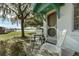 Small patio with white chairs and a table, overlooking the lake at 15040 Ne 248Th Avenue Rd, Fort Mc Coy, FL 32134