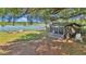 Charming screened porch and seating next to lily pad covered lake at 15040 Ne 248Th Avenue Rd, Fort Mc Coy, FL 32134