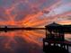 Beautiful sunset over the water with a gazebo silhouette reflecting vibrant colors at 15040 Ne 248Th Avenue Rd, Fort Mc Coy, FL 32134