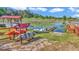 Scenic view of a waterfront property with kayaks, boat dock, and lush greenery at 15040 Ne 248Th Avenue Rd, Fort Mc Coy, FL 32134