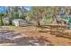 Expansive yard featuring mature trees, out building, and fenced in area at 15040 Ne 248Th Avenue Rd, Fort Mc Coy, FL 32134