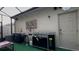 Outdoor kitchen with grill and sink in screened enclosure at 1563 Cross Prairie Pkwy, Kissimmee, FL 34744