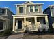 Two-story house with gray siding, front porch, and walkway at 1563 Cross Prairie Pkwy, Kissimmee, FL 34744