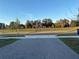House with paved walkway, grassy yard, and trees at 1563 Cross Prairie Pkwy, Kissimmee, FL 34744