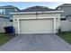 Attached garage with double door and brick driveway at 1563 Cross Prairie Pkwy, Kissimmee, FL 34744