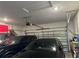 Two-car garage with overhead storage and shelving at 1563 Cross Prairie Pkwy, Kissimmee, FL 34744