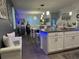 Open concept kitchen with island, white cabinets, and blue accent lighting at 1563 Cross Prairie Pkwy, Kissimmee, FL 34744