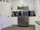 Kitchen features stainless steel refrigerator and white cabinetry at 1563 Cross Prairie Pkwy, Kissimmee, FL 34744