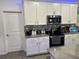 Modern kitchen with white cabinets, stainless steel appliances, and granite countertops at 1563 Cross Prairie Pkwy, Kissimmee, FL 34744