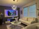 Living room featuring white sofas, coffee table, and modern chandelier at 1563 Cross Prairie Pkwy, Kissimmee, FL 34744