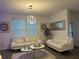 Living room with white sofas, coffee table, and large windows at 1563 Cross Prairie Pkwy, Kissimmee, FL 34744