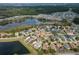 Aerial view showcasing home's location near a lake in a residential area at 16067 Shasta St, Clermont, FL 34714