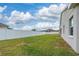Backyard with grassy area and white vinyl fence at 16067 Shasta St, Clermont, FL 34714