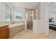 Spa-like bathroom with a soaking tub and walk-in shower at 16067 Shasta St, Clermont, FL 34714