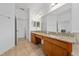 Double vanity bathroom with granite countertops and large mirror at 16067 Shasta St, Clermont, FL 34714