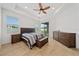 Bright bedroom with a queen-size bed and wood furniture at 16067 Shasta St, Clermont, FL 34714