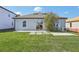 Spacious backyard with lush lawn, patio, and thoughtfully designed landscaping at 1609 Hill Park Dr, Deltona, FL 32725