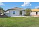 Lush backyard with green grass, a patio, and view of the home's exterior at 1609 Hill Park Dr, Deltona, FL 32725