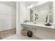 Modern bathroom featuring a vanity with double sinks, marble floors, and a walk-in closet at 1609 Hill Park Dr, Deltona, FL 32725