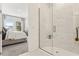 Bright bathroom with a glass-enclosed shower stall and a view into the adjacent bedroom at 1609 Hill Park Dr, Deltona, FL 32725