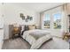 A well-lit bedroom with a neutral palette, large windows, and stylish decor at 1609 Hill Park Dr, Deltona, FL 32725