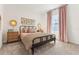 Bright bedroom features a black bed frame, pink curtains, and unique bedside lighting at 1609 Hill Park Dr, Deltona, FL 32725