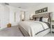 Bedroom featuring neutral walls, carpet flooring, and a tufted headboard with decorative pillows at 1609 Hill Park Dr, Deltona, FL 32725