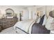 Bedroom with a decorative mirror over a wooden dresser and a glimpse into the hallway at 1609 Hill Park Dr, Deltona, FL 32725