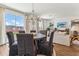 Open dining room with chandelier and access to kitchen and living spaces at 1609 Hill Park Dr, Deltona, FL 32725