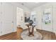 Bright foyer with wood floors, round rug, and a decorative table next to the front door at 1609 Hill Park Dr, Deltona, FL 32725
