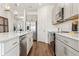 Modern kitchen featuring stainless steel appliances, gray cabinets, and hardwood flooring at 1609 Hill Park Dr, Deltona, FL 32725