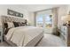 Comfortable main bedroom with a tufted headboard, neutral decor, and a view of the outdoors at 1609 Hill Park Dr, Deltona, FL 32725
