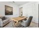 Neutral office with a light wood table, modern chair, and serene artwork at 1609 Hill Park Dr, Deltona, FL 32725