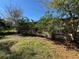 The side yard has healthy green grass, foliage, and is partially shaded from the sun at 2101 La Due Ct, Orlando, FL 32811