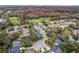 An aerial view showcasing the neighborhood and mature trees. The local golf course is in the background at 231 Chestnut Ridge St, Winter Springs, FL 32708