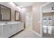 Bright bathroom with double sink vanity, access to walk-in closet and bedroom overlooking the pool at 231 Chestnut Ridge St, Winter Springs, FL 32708