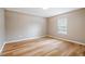 Cozy bedroom with wood flooring and a window providing natural light at 231 Chestnut Ridge St, Winter Springs, FL 32708